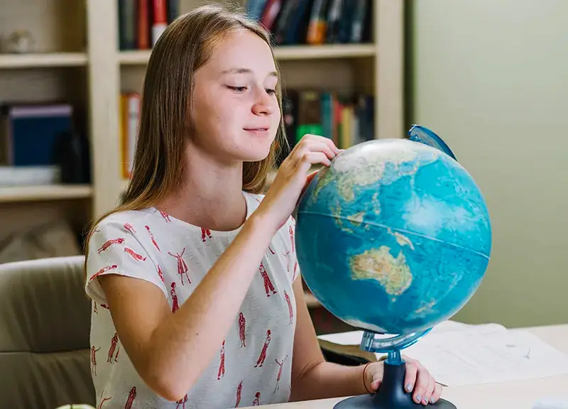 Student with Globe
