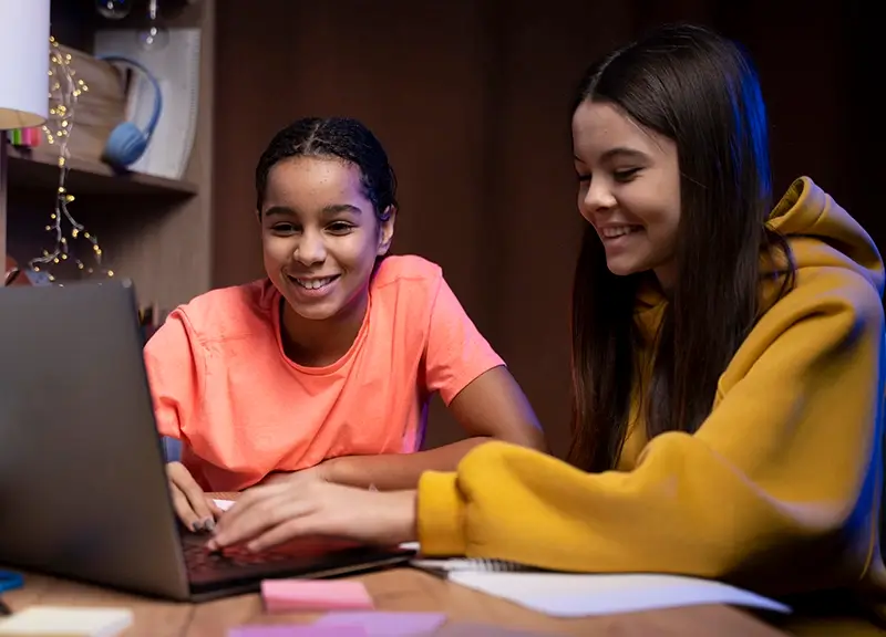 Two Teenage Girls Studying Laptop