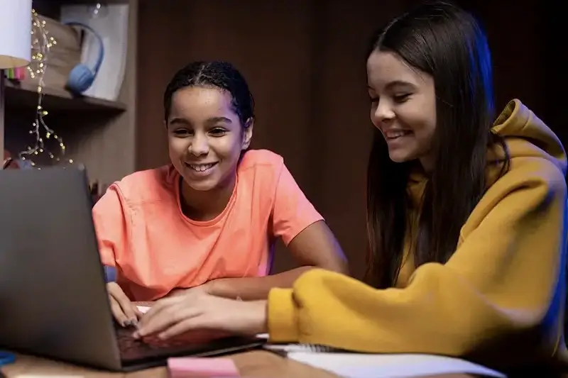 Two Teenagers Studying Laptop